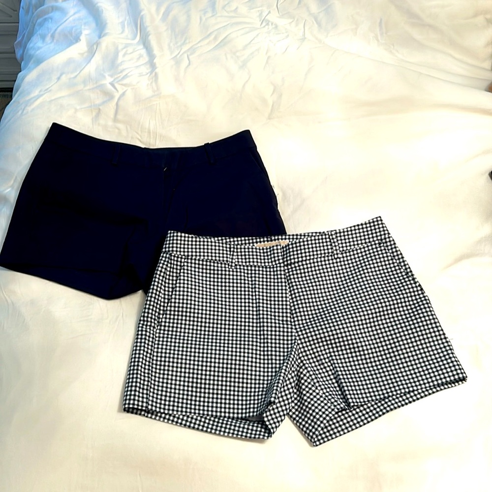 Two pairs of Michael Kors shorts size two.One solid black other navy and white